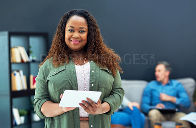 Buy stock photo Portrait of a young businesswoman using a digital tablet with her team in the background