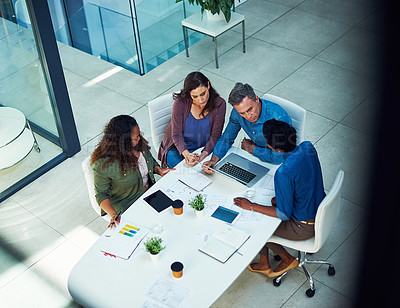 Buy stock photo High angle shot of a group of designers having a meeting in an office