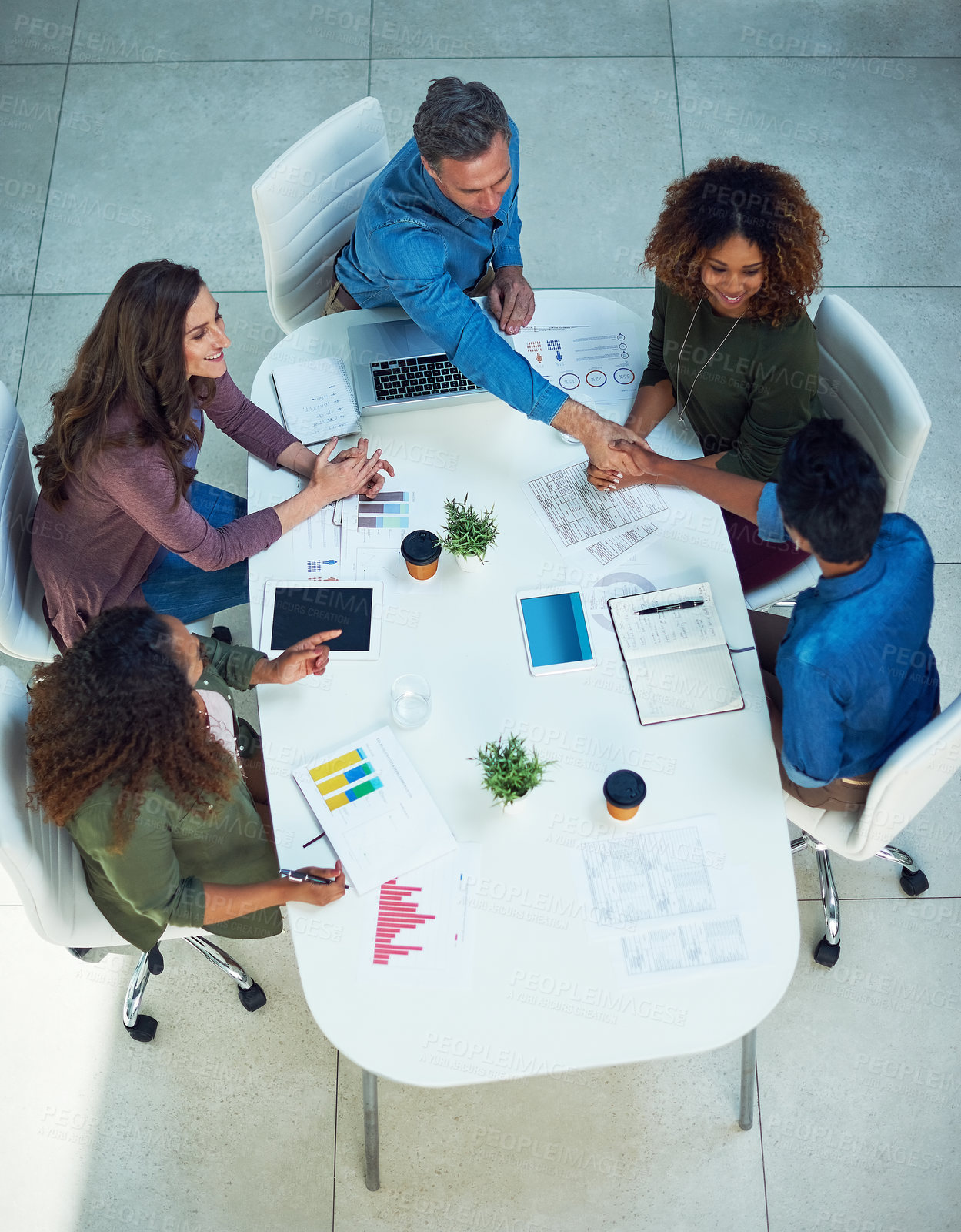 Buy stock photo Shot of a group of coworkers meeting in the boardroom