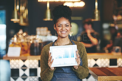 Buy stock photo Shot of a young woman holding a digital tablet with a graph on the screen at a coffee shop