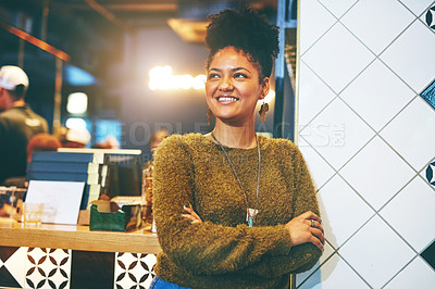 Buy stock photo Shot of a happy young woman looking away thoughtfully in a coffee shop