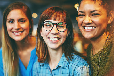 Buy stock photo Portrait of three young friends hanging out together in a cafe