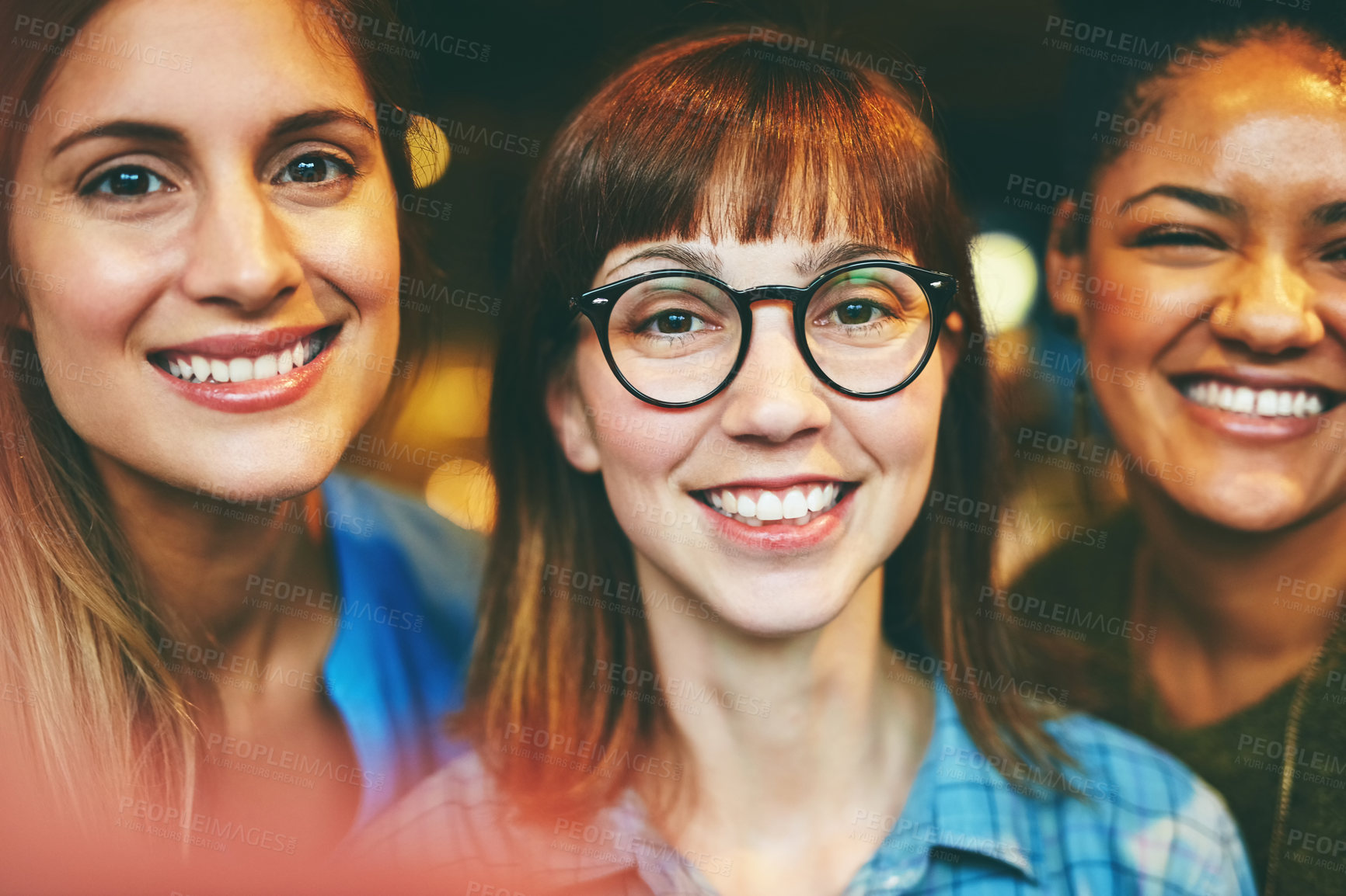 Buy stock photo Portrait of three young friends hanging out together in a cafe