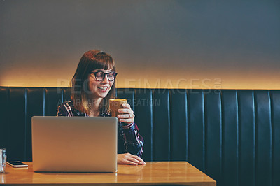 Buy stock photo Cropped shot of an attractive young woman using her laptop in a cafe