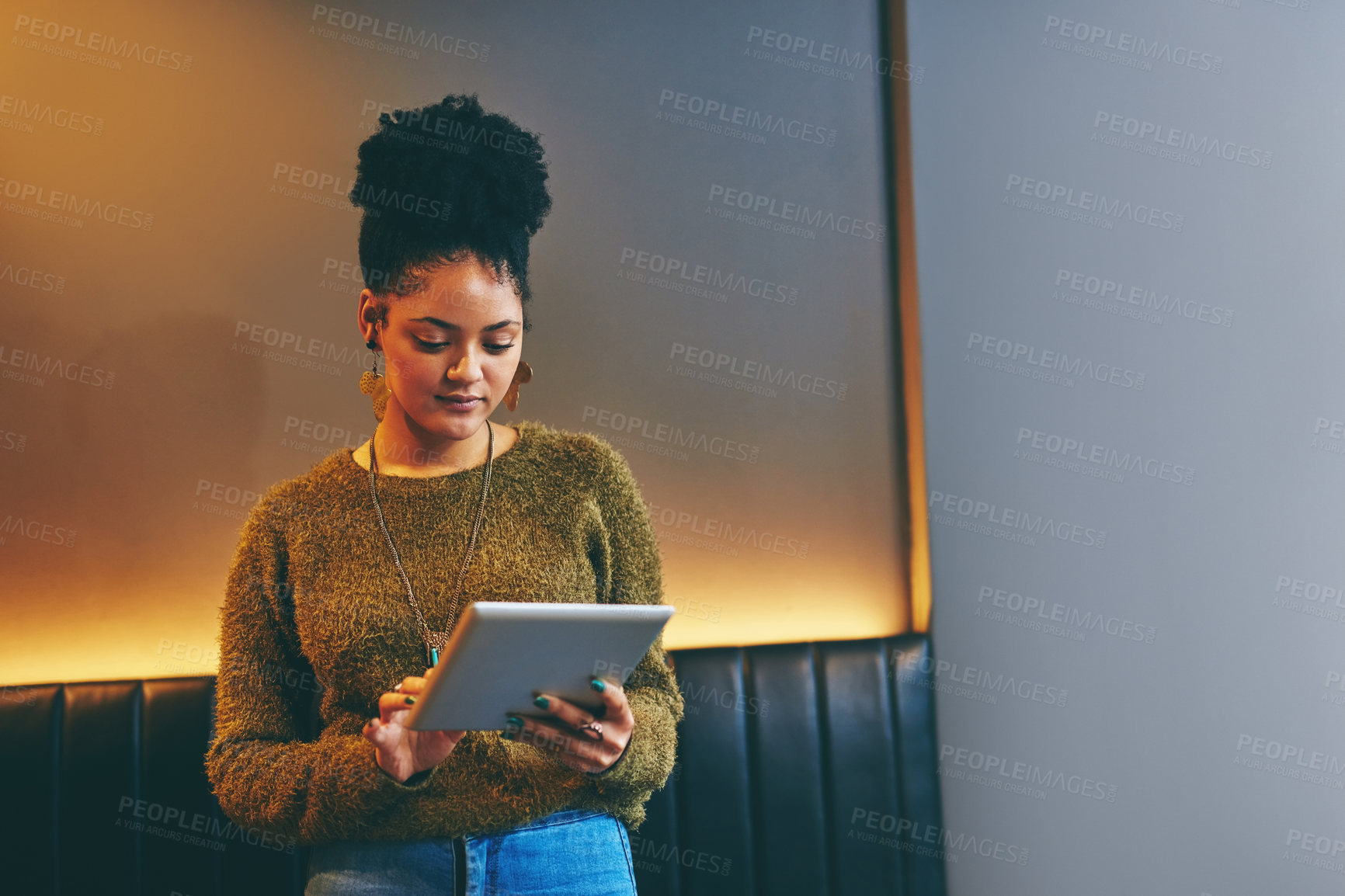 Buy stock photo Shot of an attractive young woman using a digital tablet