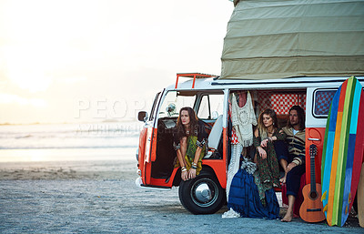 Buy stock photo Shot of a group of young friends stopping at the beach during a roadtrip