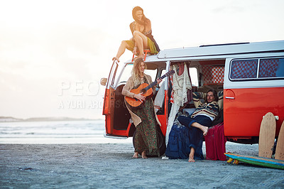Buy stock photo Shot of a group of young friends stopping at the beach during a roadtrip