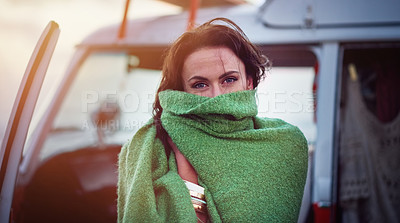 Buy stock photo Portrait of an attractive young woman wrapped in a blanket on the beach