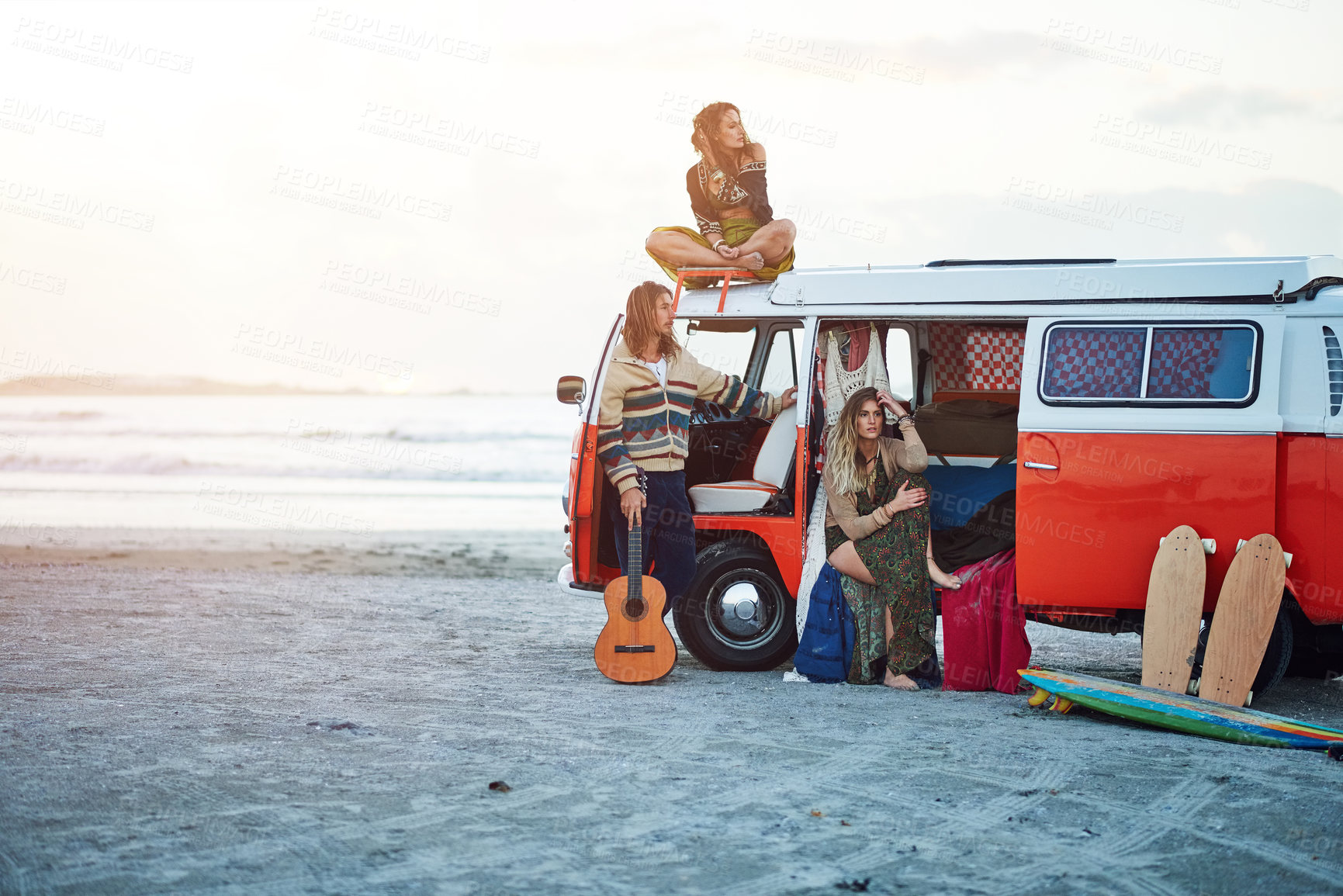 Buy stock photo Shot of a group of young friends stopping at the beach during a roadtrip