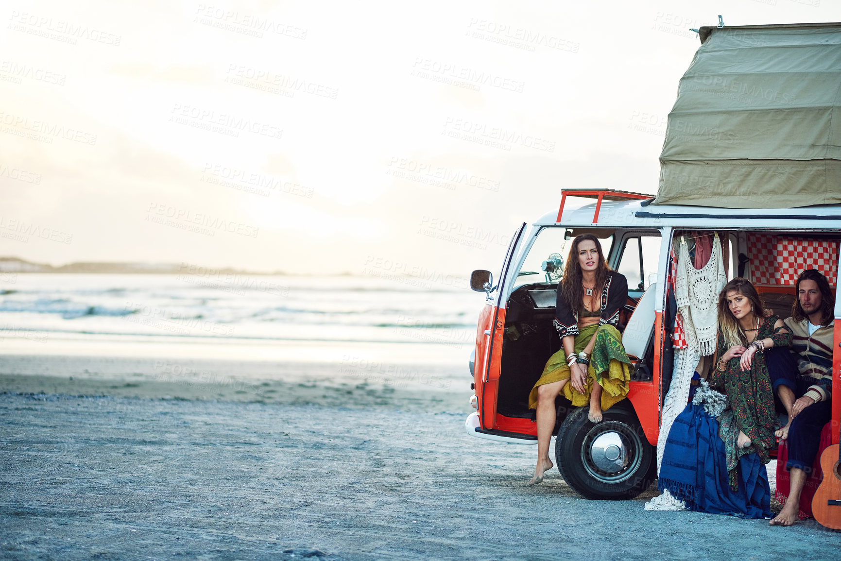 Buy stock photo Shot of a group of young friends stopping at the beach during a roadtrip