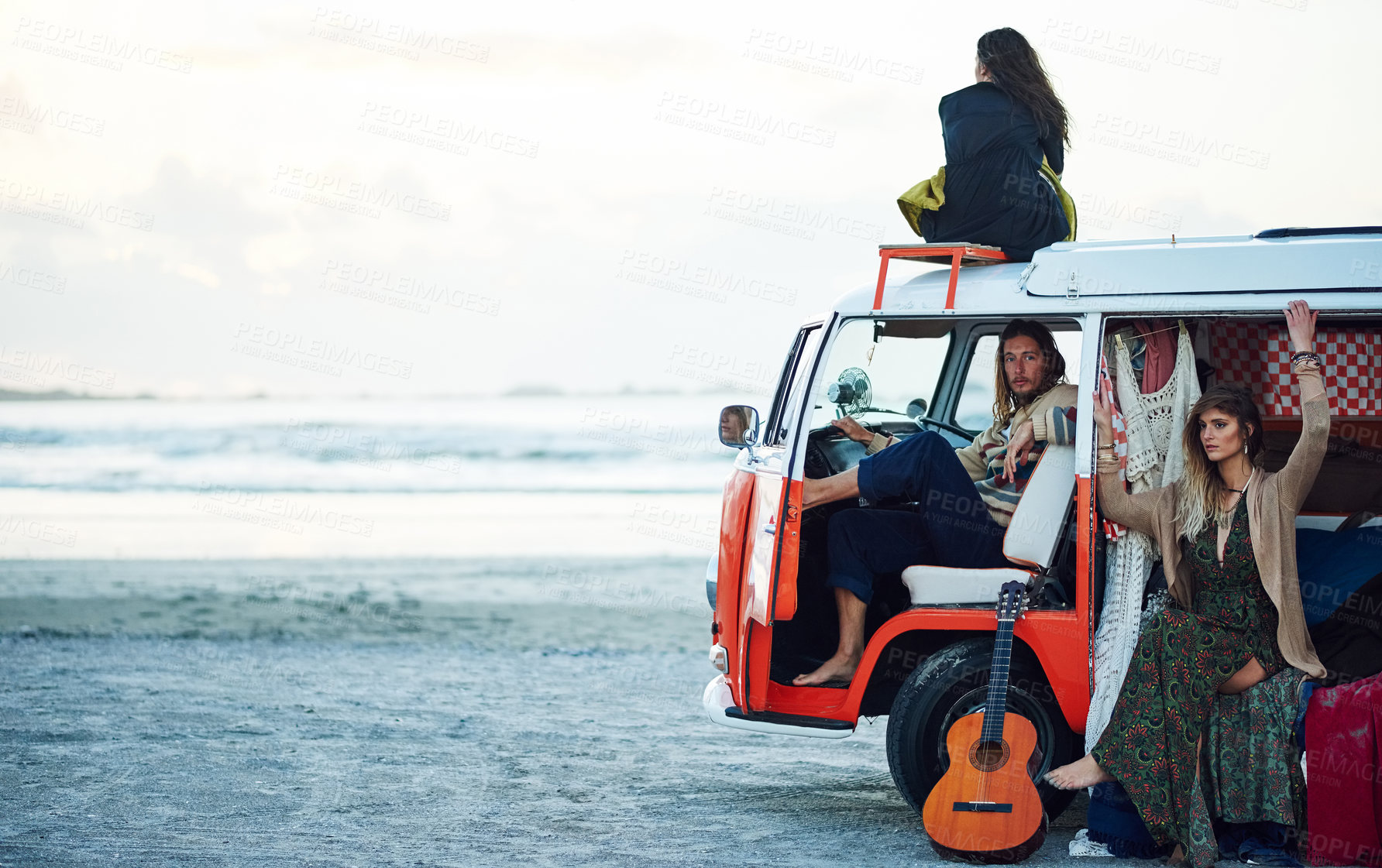 Buy stock photo Shot of a group of young friends stopping at the beach during a roadtrip