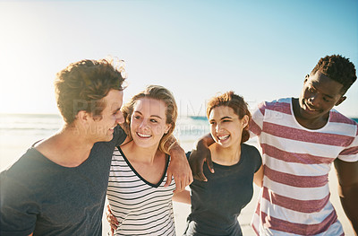 Buy stock photo Shot of a happy group of friends enjoying a day together at the beach
