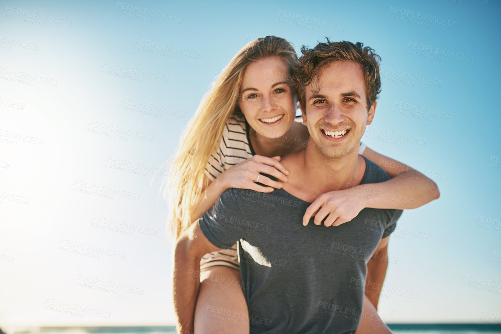 Buy stock photo Portrait, piggyback and ocean with couple, love or sunshine with happiness, honeymoon or romance. Face, seaside or man carrying woman with vacation, adventure and summer with journey, beach or smile