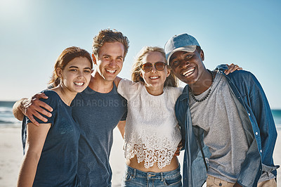 Buy stock photo Portrait of a group of happy young friends posing on the beach together