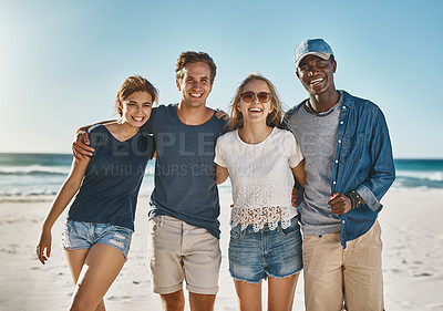 Buy stock photo Portrait of a group of happy young friends posing on the beach together