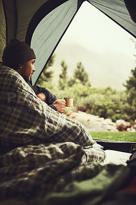 Buy stock photo Cropped shot of young man sitting in his tent at a campsite