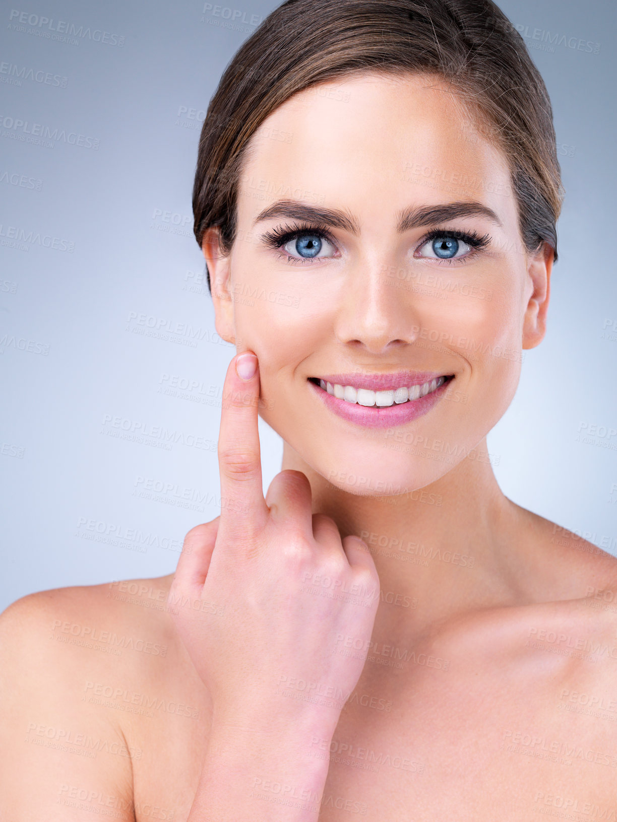 Buy stock photo Studio shot of a beautiful young woman posing against a grey background