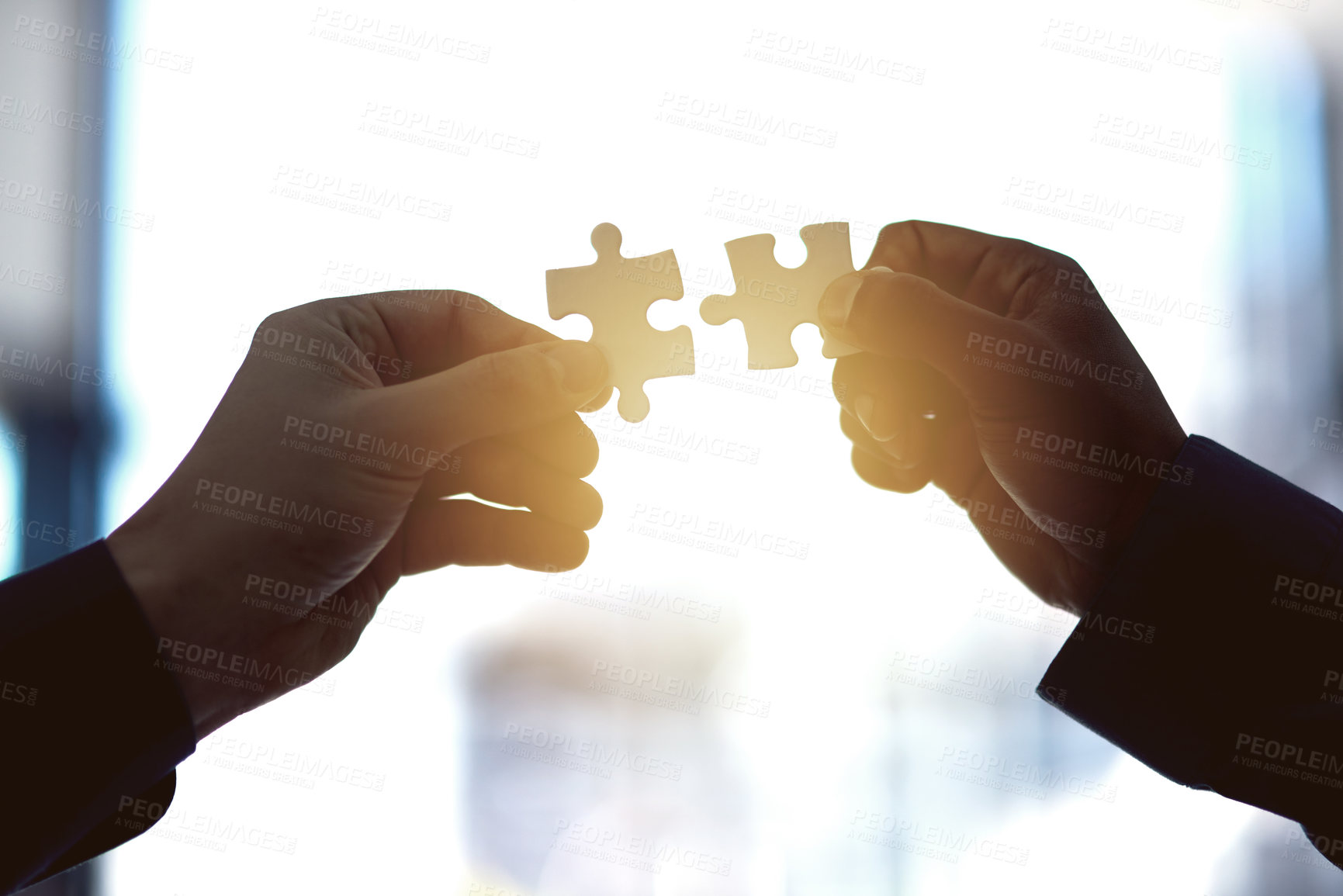 Buy stock photo Cropped shot of two people holding puzzle pieces together