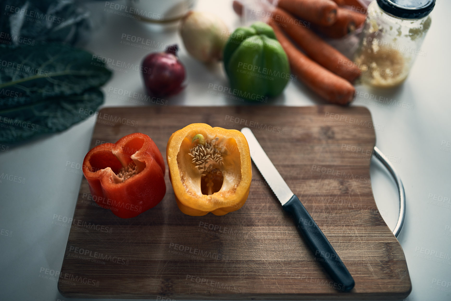 Buy stock photo High angle shot of chopped peppers on a cutting board surround by various vegetables on a kitchen counter
