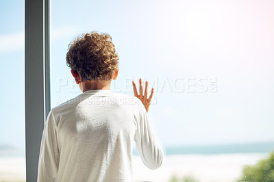 Buy stock photo Sad, depression and hope of a child at window while bored lonely and thinking. Depressed, psychology and autism boy child with anxiety problem in isolation with hand by mockup space in house