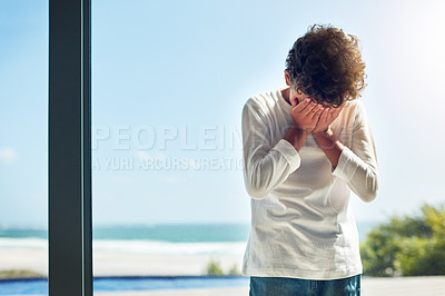 Buy stock photo Sad, depression and crying child with hands covering face while lonely and unhappy. Depressed, psychology and scared boy kid with anxiety problem, grief or upset in isolation in a house