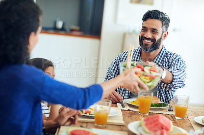 Buy stock photo Shot of a happy family gathered around their table for a meal