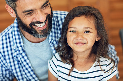 Buy stock photo Portrait of a happy little girl sitting on her father's lap at home