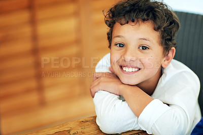 Buy stock photo Portrait of an adorable little boy posing at the table at home