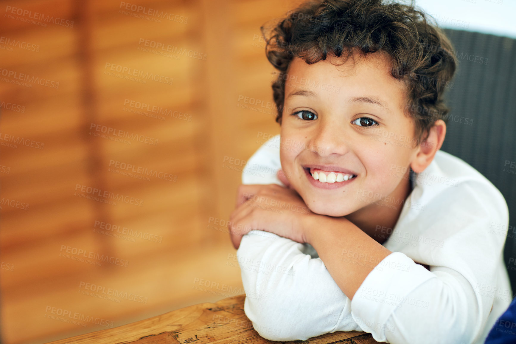 Buy stock photo Portrait of an adorable little boy posing at the table at home