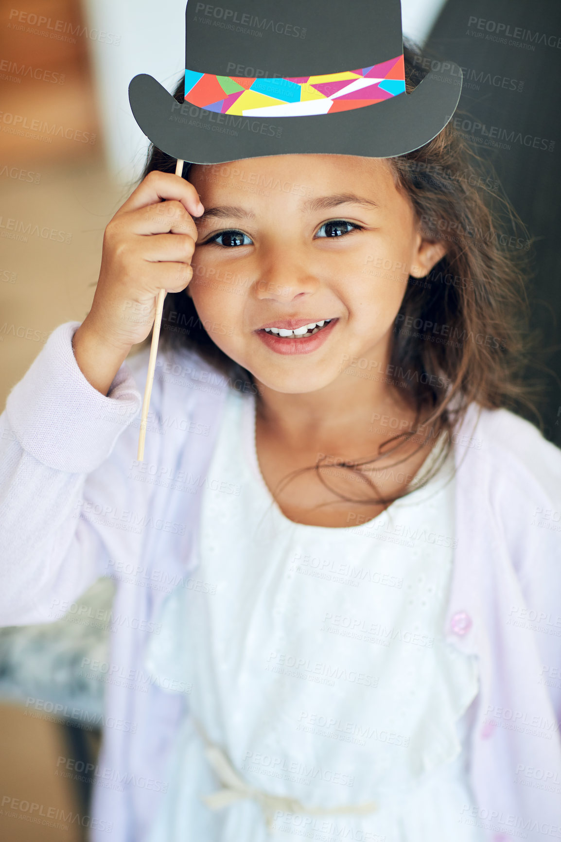 Buy stock photo Portrait of a cute little girl posing with dress-up props at home