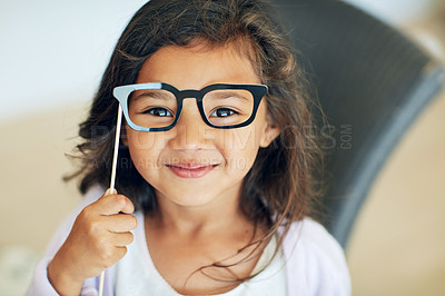 Buy stock photo Portrait of a cute little girl posing with dress-up props at home