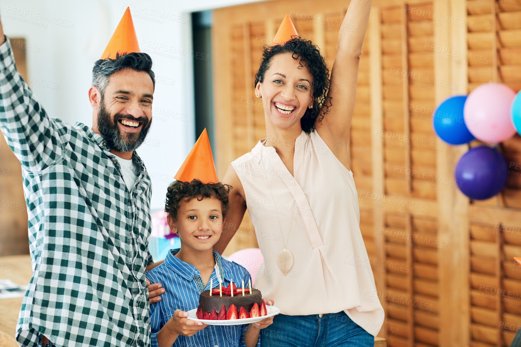 Buy stock photo Portrait of a happy little boy celebrating his birthday with his parents at home