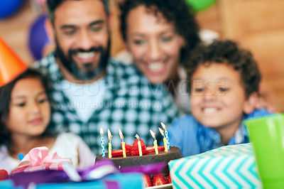 Buy stock photo Shot of a happy little boy celebrating his birthday with his family at home