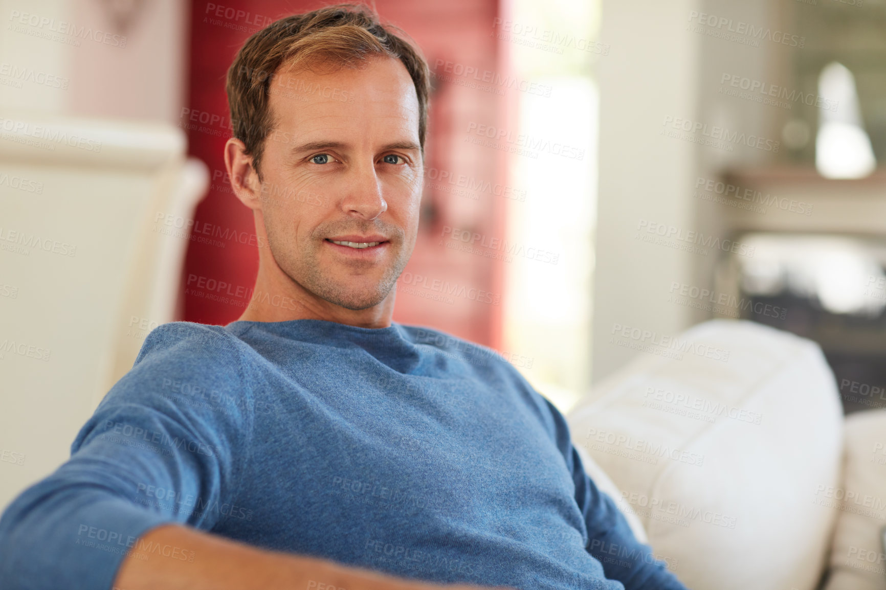 Buy stock photo Cropped portrait of a handsome man relaxing at home