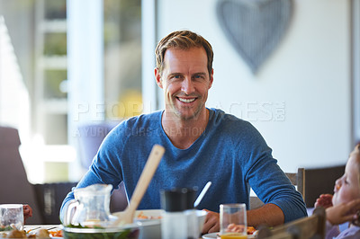Buy stock photo Portrait of a father and his little daughter enjoying a meal together at home