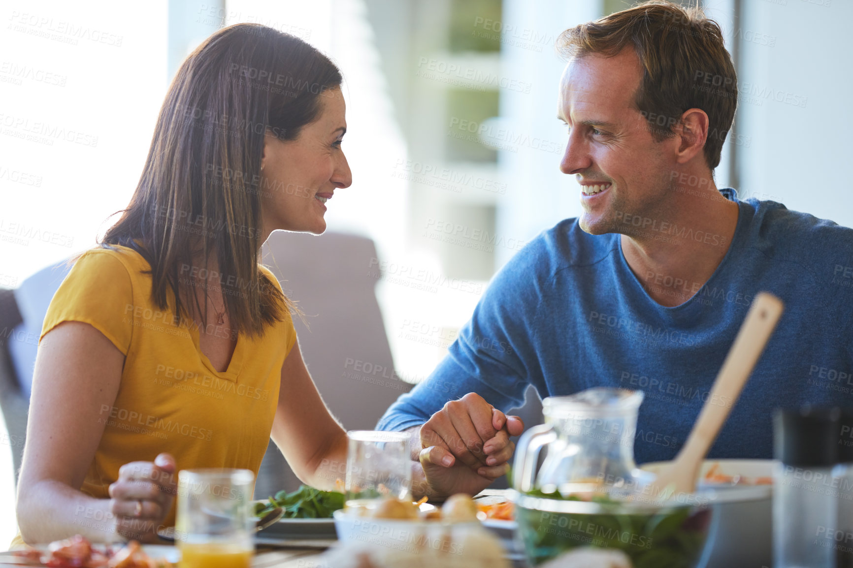 Buy stock photo Cropped shot of a mature couple enjoying a meal together at home