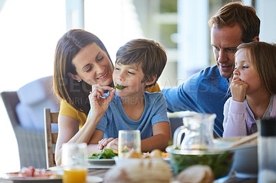 Buy stock photo Cropped shot of a family enjoying a meal together at home