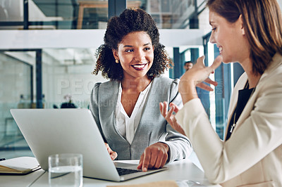 Buy stock photo Cropped shot of two corporate businesswomen having a discussion in an office