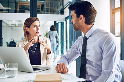 Buy stock photo Cropped shot of two corporate businesspeople having a discussion in an office