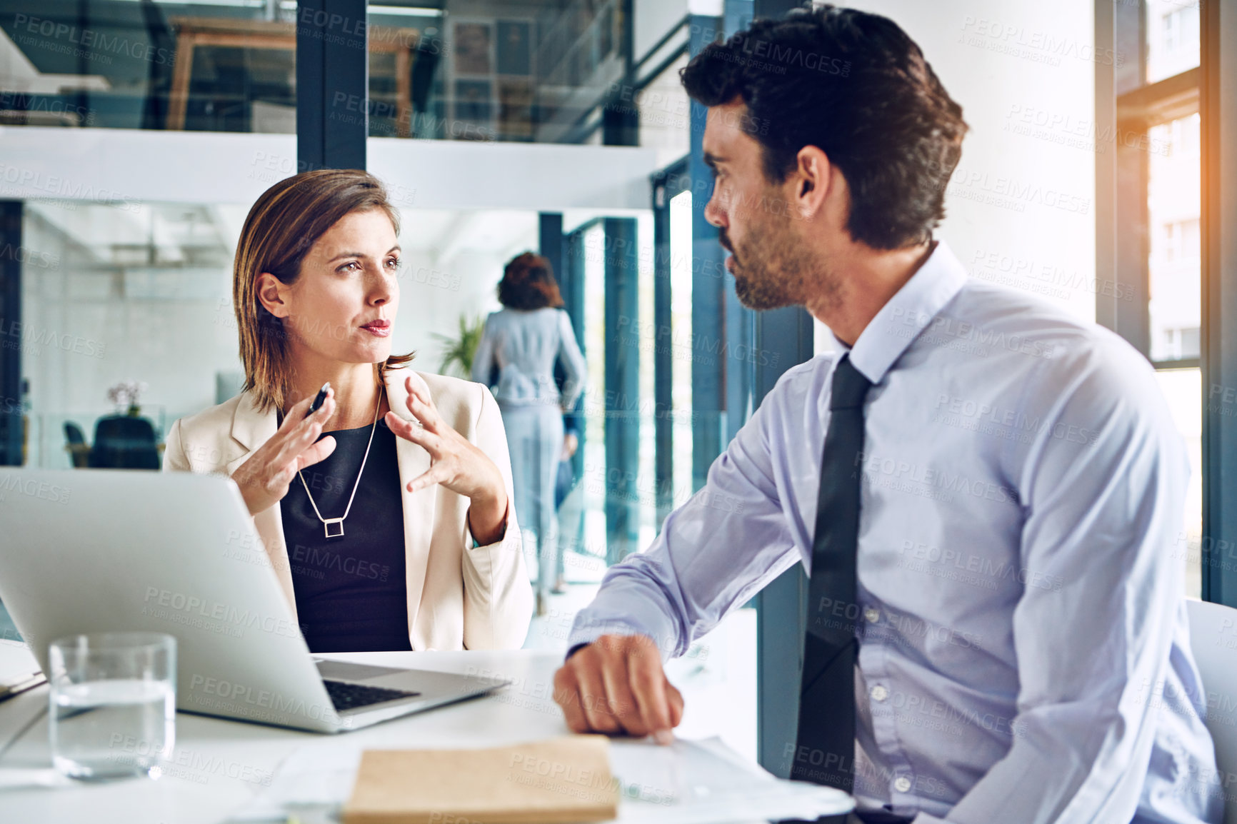 Buy stock photo Cropped shot of two corporate businesspeople having a discussion in an office