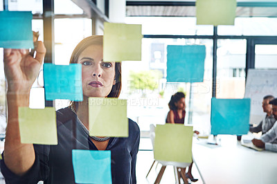 Buy stock photo Shot of a young businesswoman having a brainstorming session at work