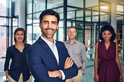 Buy stock photo Portrait of a team of confident professionals standing together in a modern office