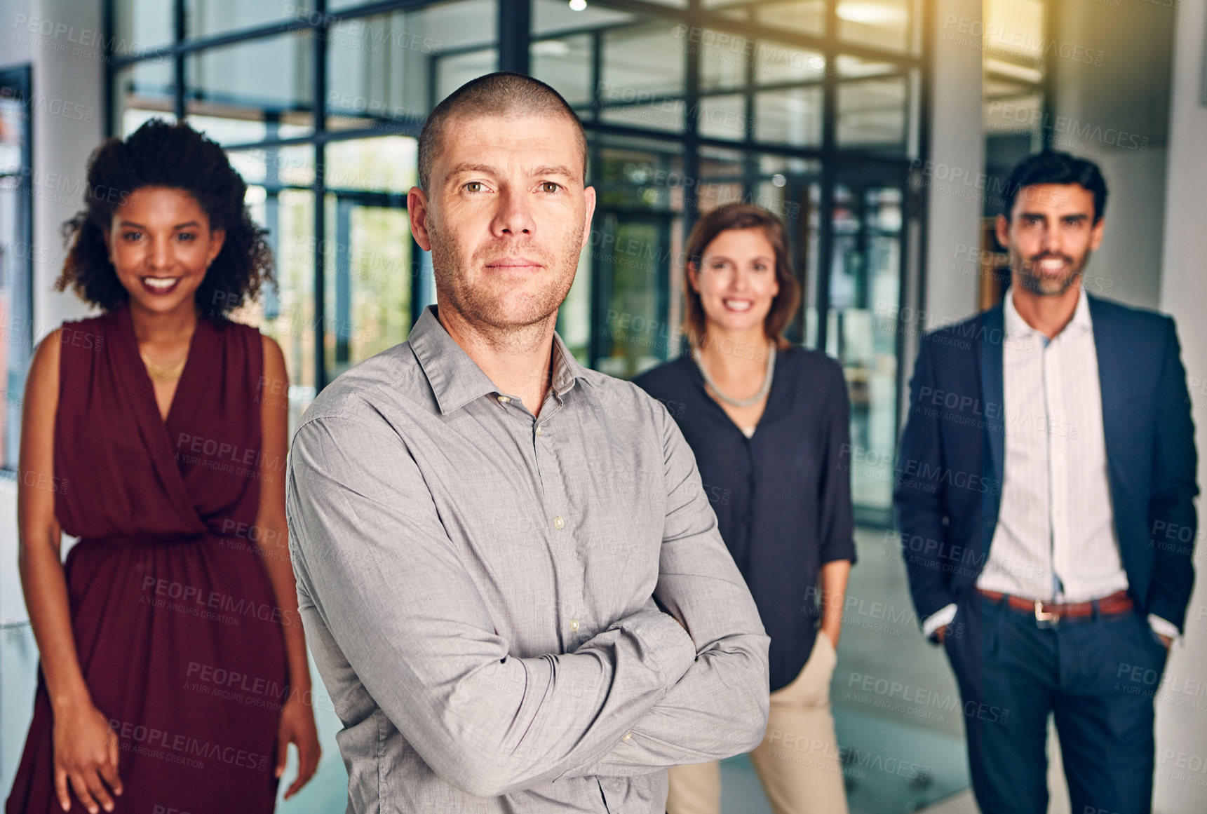 Buy stock photo Portrait of a team of confident professionals standing together in a modern office