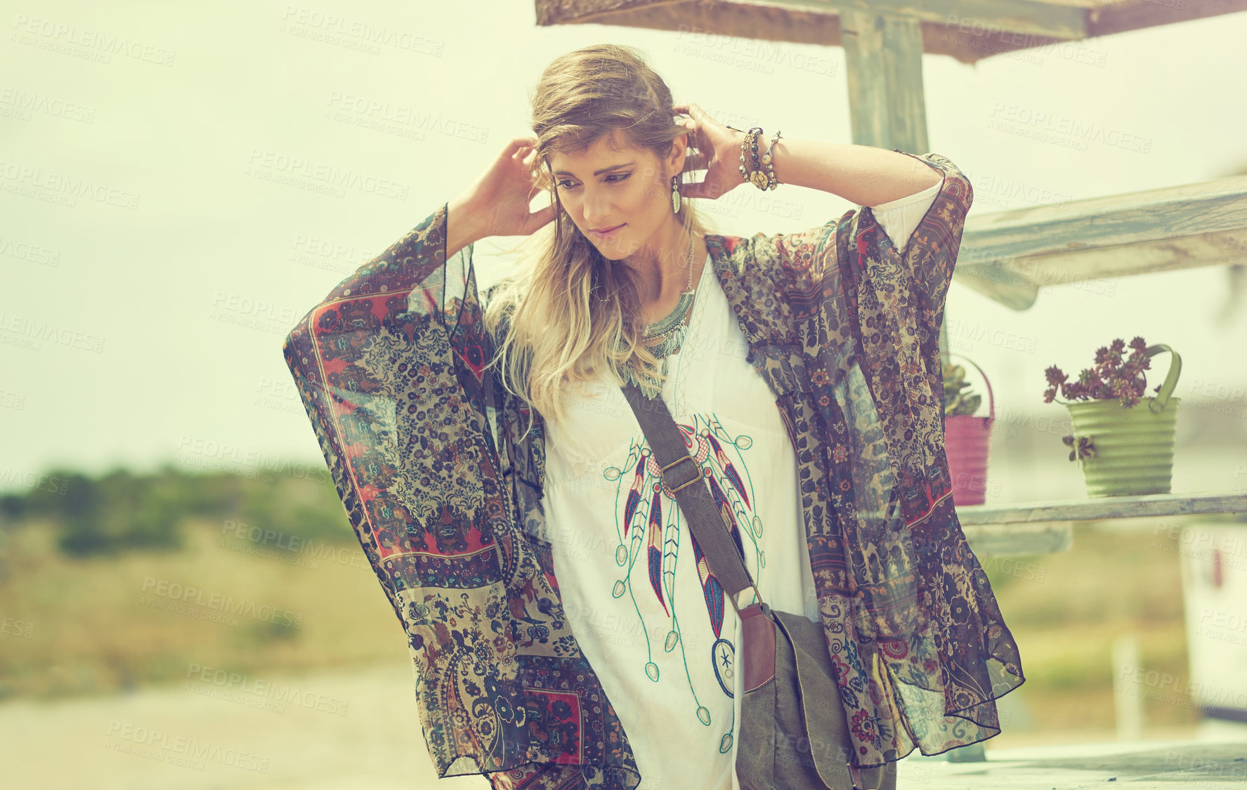 Buy stock photo Shot of a bohemian young woman spending a summer day outside