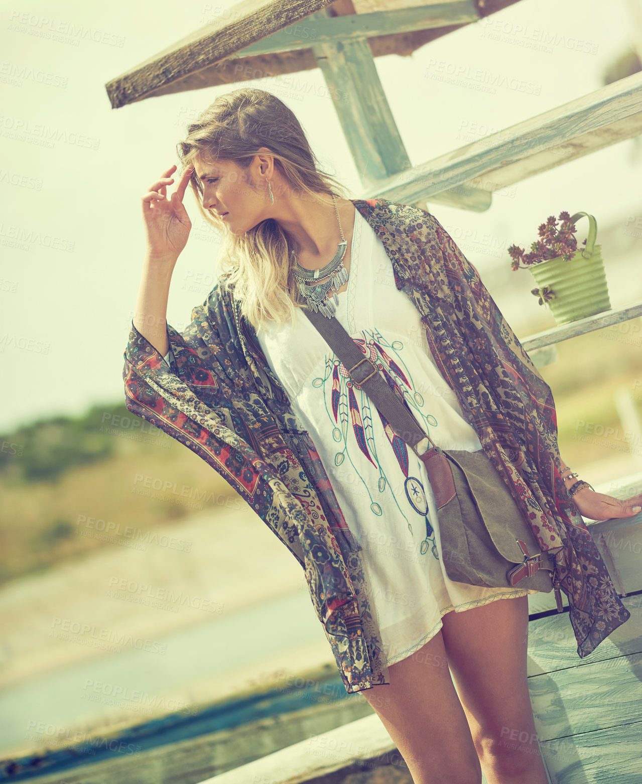 Buy stock photo Shot of a bohemian young woman spending a summer day outside