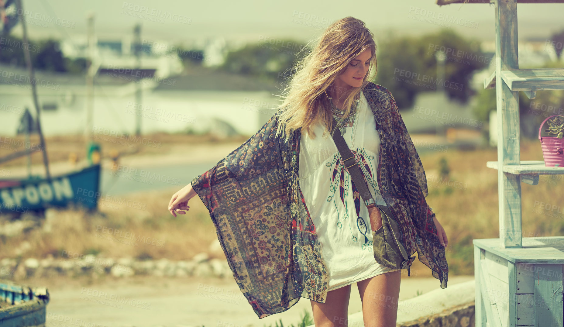 Buy stock photo Shot of a bohemian young woman spending a summer day outside