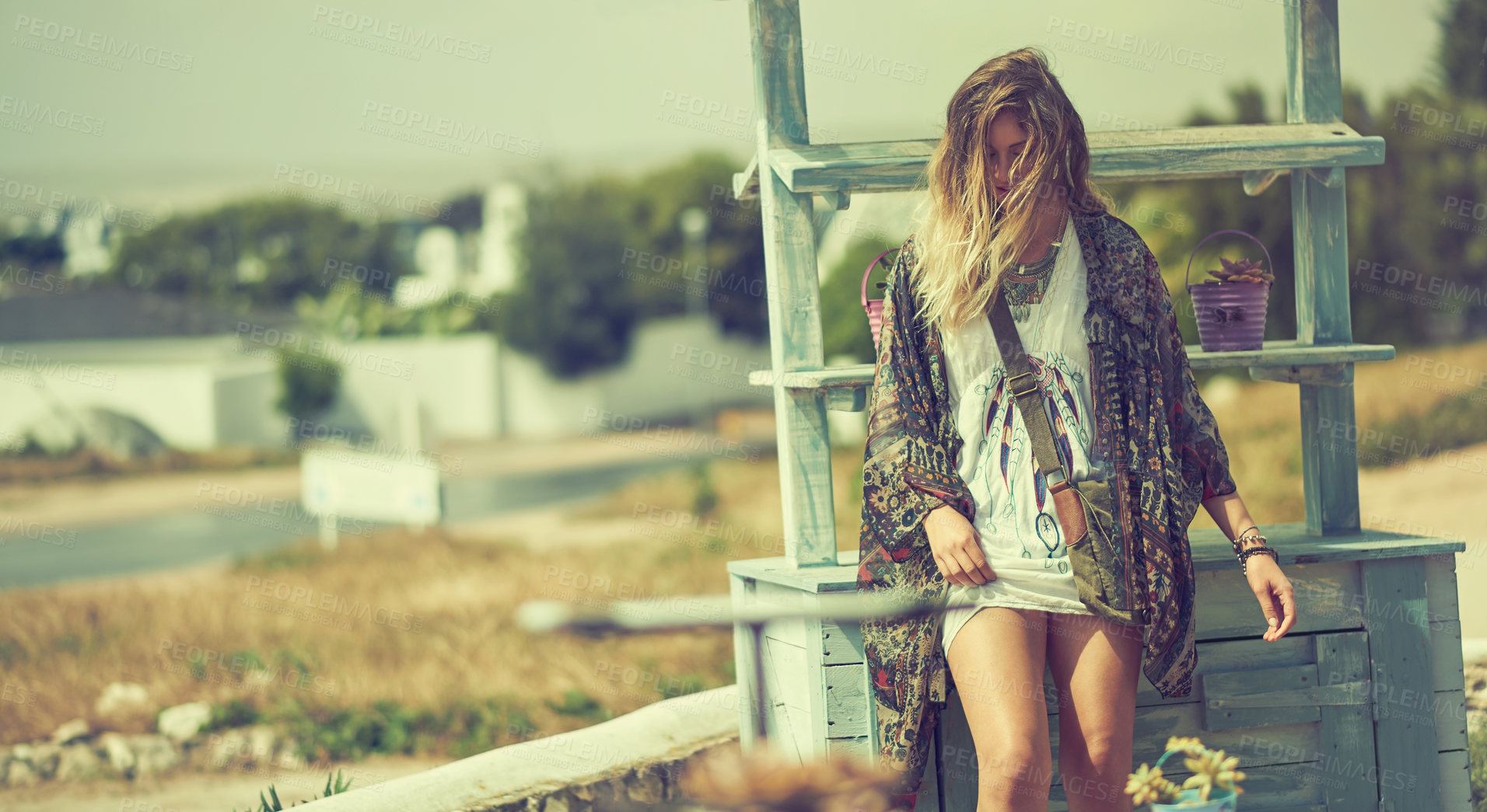 Buy stock photo Shot of a bohemian young woman spending a summer day outside