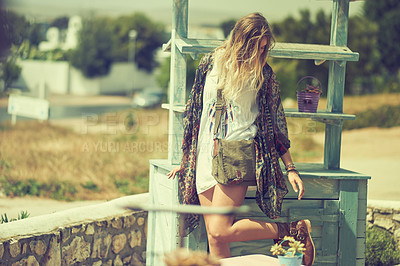 Buy stock photo Shot of a bohemian young woman spending a summer day outside