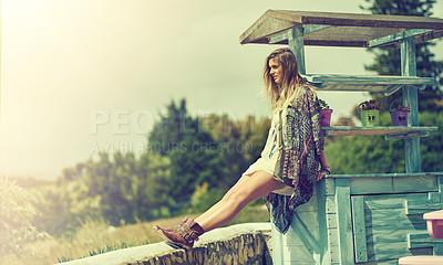 Buy stock photo Shot of a fashionable young woman posing outside on a sunny day