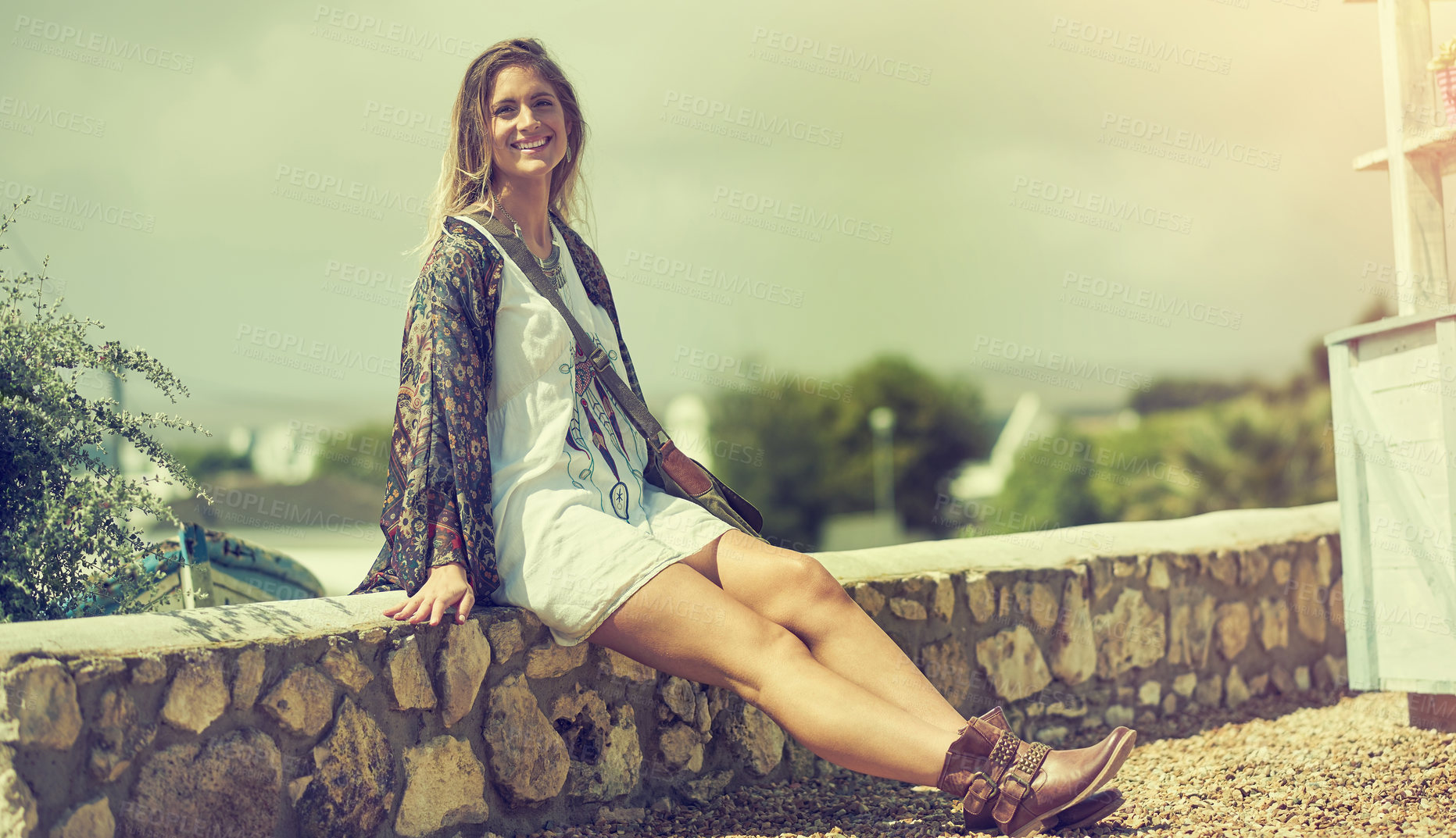 Buy stock photo Shot of a free spirited young woman enjoying the sunshine outside